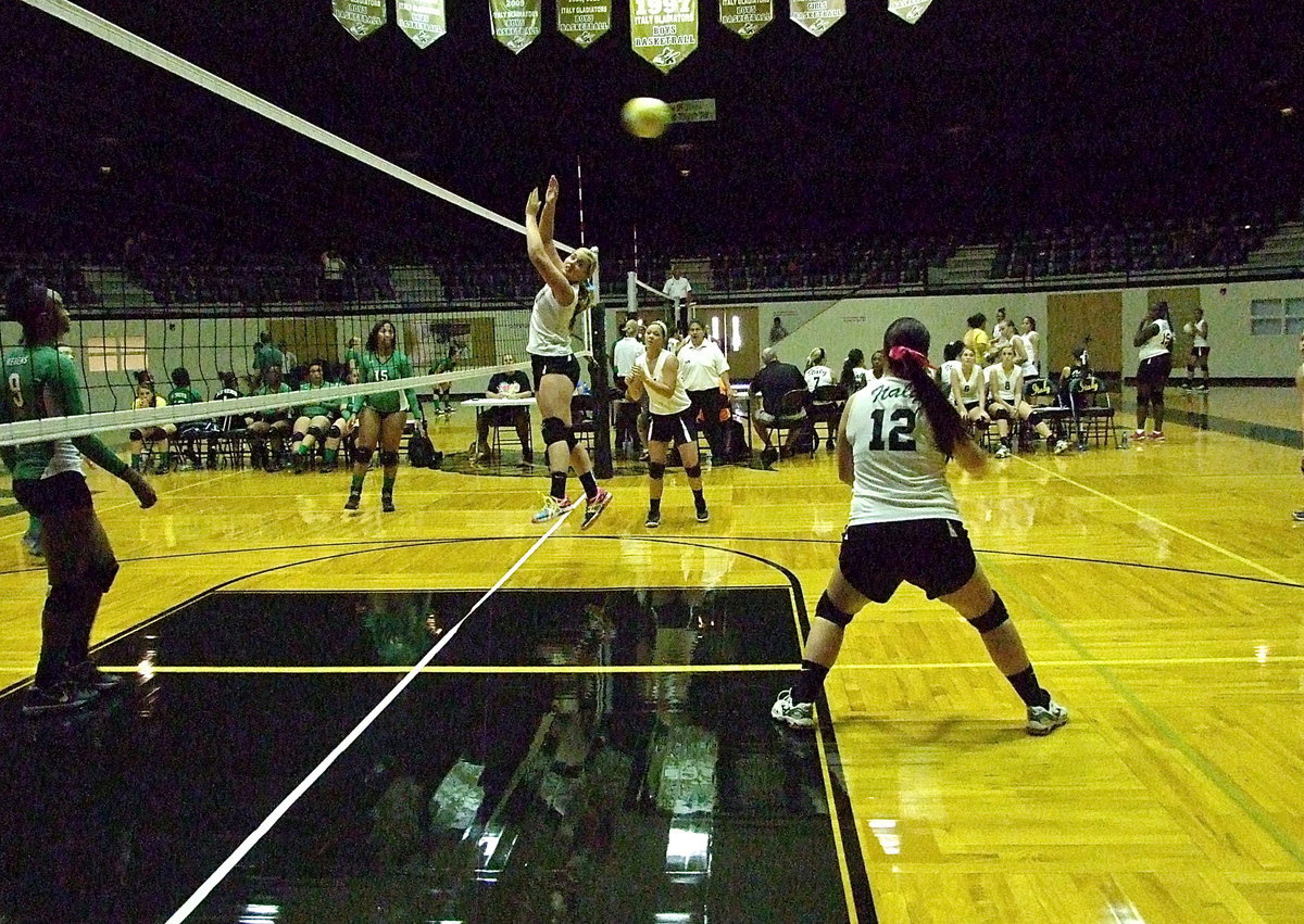 Image: Paige Westbrook(12) reacts to a crosscourt return from Kerens that evades teammates Madison Washington(10) and Bailey Eubank(7).