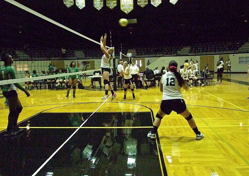 Image: Paige Westbrook(12) reacts to a crosscourt return from Kerens that evades teammates Madison Washington(10) and Bailey Eubank(7).