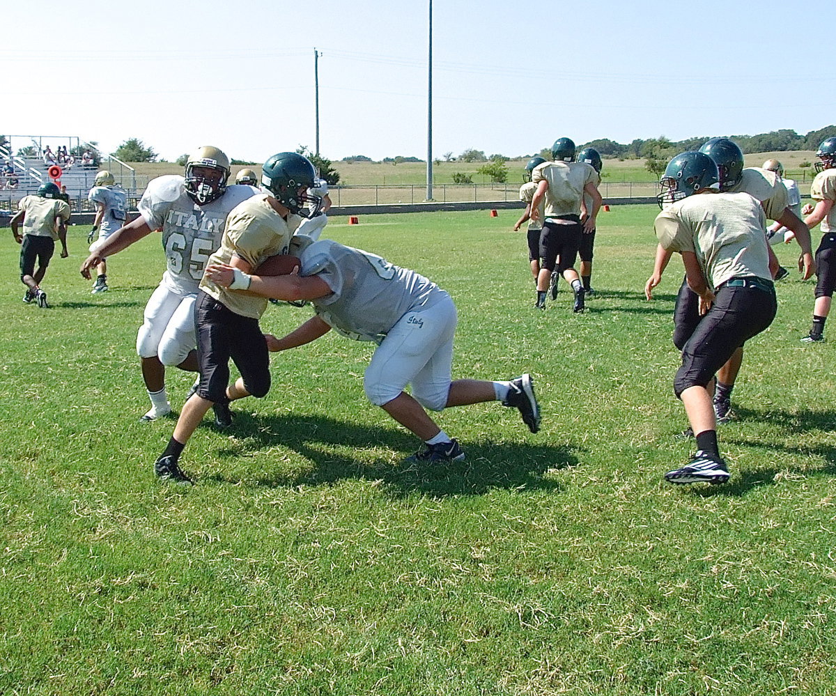Image: Darol Mayberry(65) and Zain Byers(60) force the referees to blow the whistle as they share a sack against Valley Mills.