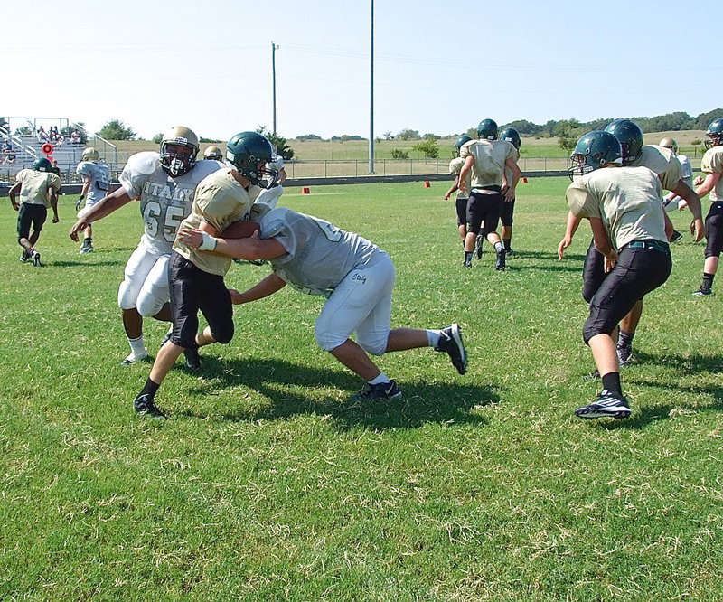 Image: Darol Mayberry(65) and Zain Byers(60) force the referees to blow the whistle as they share a sack against Valley Mills.