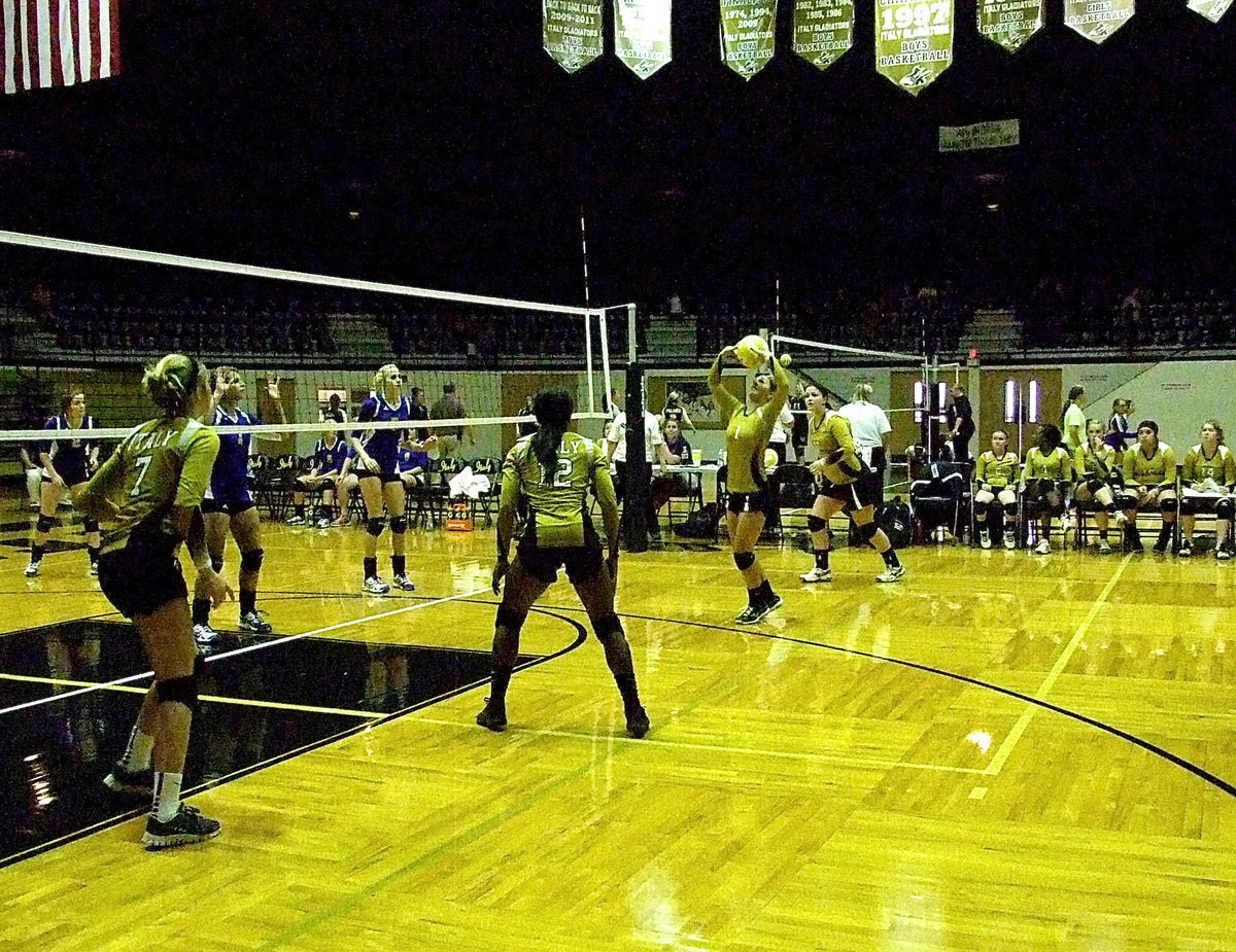Image: Bailey Eubank(1) sets the ball for Kortnei Johnson(12) with Halee Turner(7) at the ready.