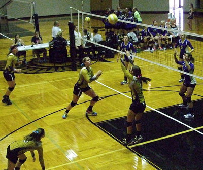 Image: Bailey Eubank(1) sets the ball for Madison Washington(10) who is ready to strike.