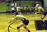 Image: Bailey Eubank(1), Madison Washington(10) and Jaclynn Lewis(13) await MIldred’s serve…