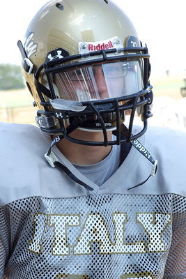 Image: JV Gladiator Hunter Ballard is protected by his shield.
