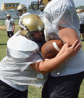 Image: Samuel Corley does the tackling drill as he and his JV teammates prepared for Malakoff during the week leading up to the game.