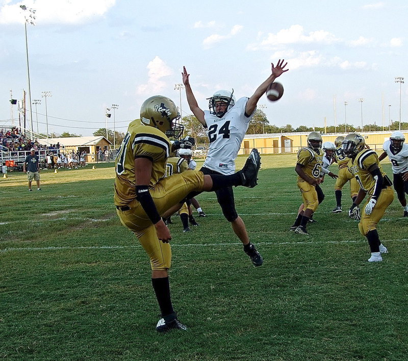 Image: David De La Hoya(60) gets the punt away despite a Malakoff defender getting a piece of the ball.