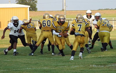 Image: Quarterback Joe Celis(2) turns to handoff to Johnny Norris(7) with Kenneth Norwood, Jr.(63), David De La Hoya(60) and Samuel Corley(76) leading the way.