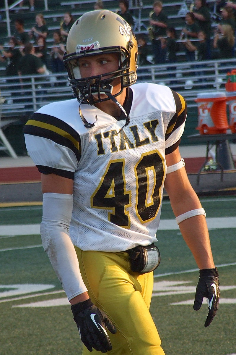 Image: Italy’s Coby Bland(40) practices plays with his teammates just moments before kickoff.