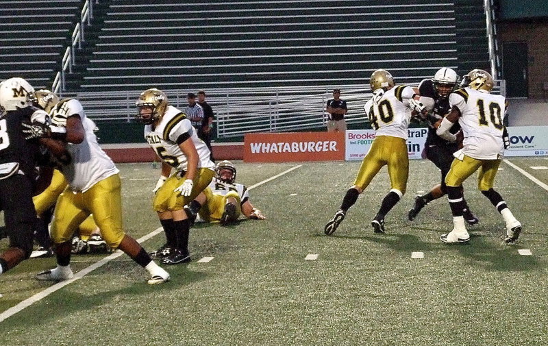 Image: Darol Mayberry(58), Shad Newman(25) and Coby Bland(40) give quarterback TaMarcus Sheppard(10) time to pass downfield.
