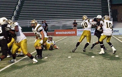 Image: Darol Mayberry(58), Shad Newman(25) and Coby Bland(40) give quarterback TaMarcus Sheppard(10) time to pass downfield.