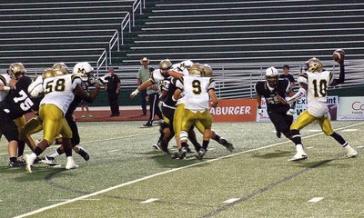 Image: Italy’s Darol Mayberry(58) and Hunter Merimon(9) allow quarterback TaMarcus Sheppard(10) time to pass the ball.