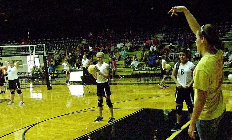 Image: Sophomore Lady Gladiator Lillie “Coach” Perry helps the Junior High girls during pre-game drills.