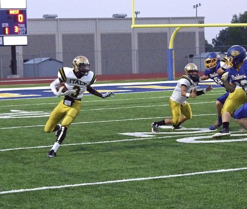 Image: Trevon Robertson(3) returns the opening kickoff for Italy with teammate Tyler Anderson trying to provide resistance.