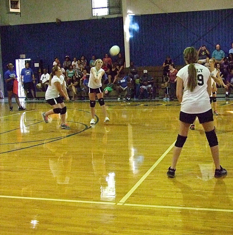 Image: Annie Perry(13) keeps the volley going with Brianna Hall(38) backing her up.