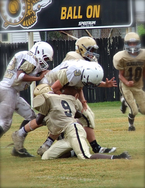 Image: Low man wins: Chasston Wilson(9) lowers his pad level to make the tackle on a Jaguar runner.