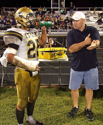 Image: Alumni Gladiator Jackie Cate offers some old school advice to inside linebacker Shad Newman(25).