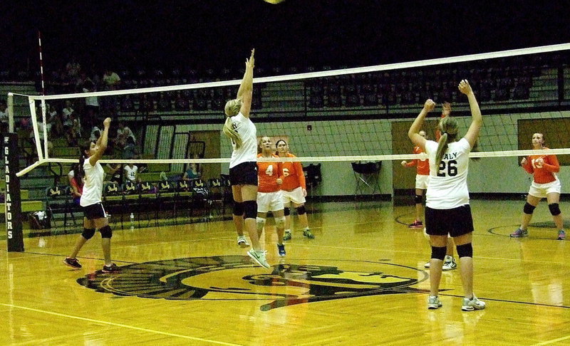 Image: Marlen Hernandez, Annie Perry(13) and Sydney Weeks put do work at the front near the net.