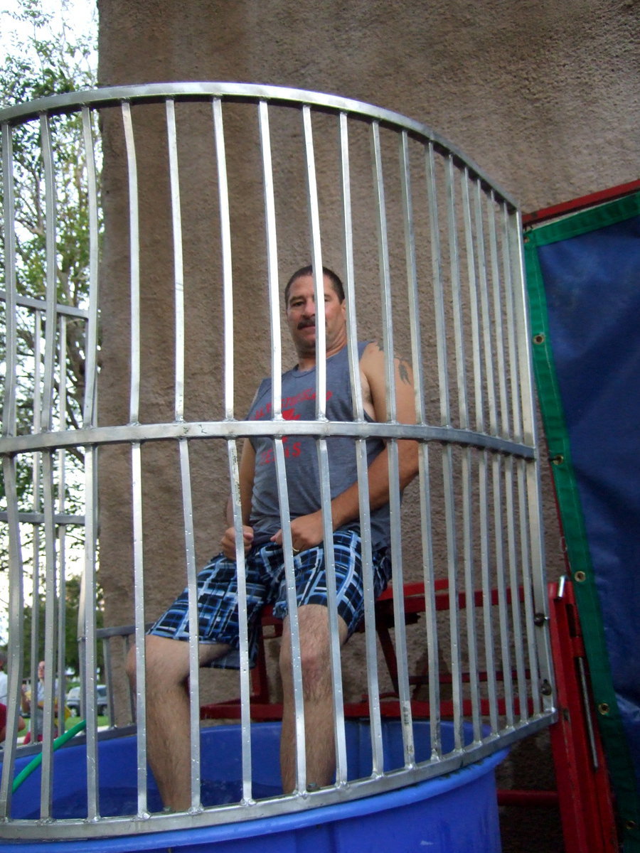 Image: Milford Police Chief Carlos Phoenix is quite a sport taking his turn in the dunking booth.