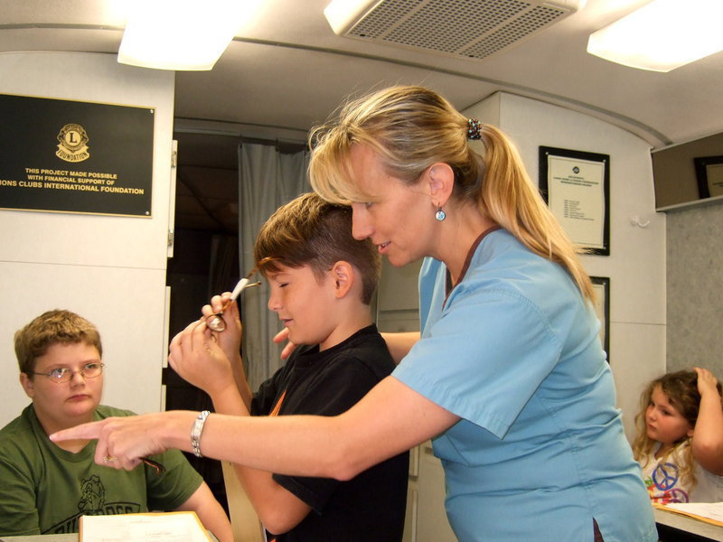 Image: Dr. Donna Haas has been helping the Lions Club for many years fitting children in glasses.