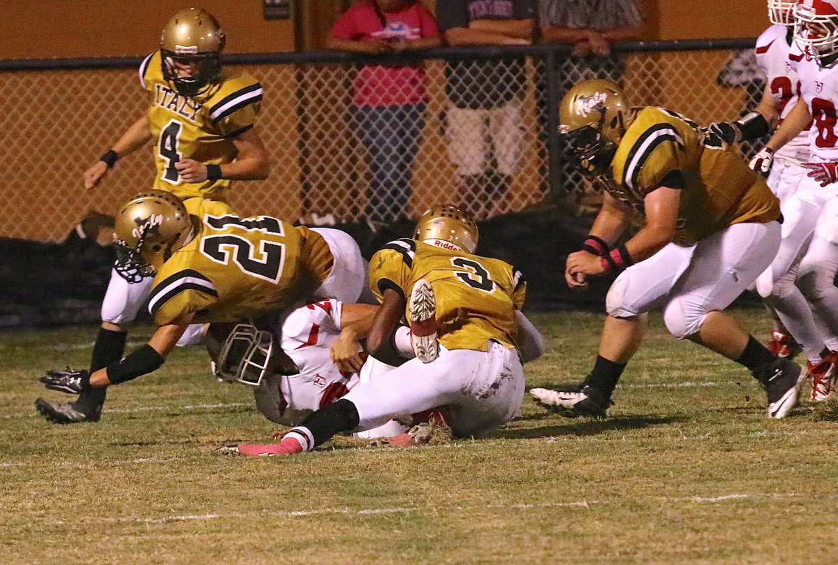 Image: Tre Robertson(3), Ryan Connor(21), Justin Wood(4) and John Byers(56) keep Hico from reaching the goal line.