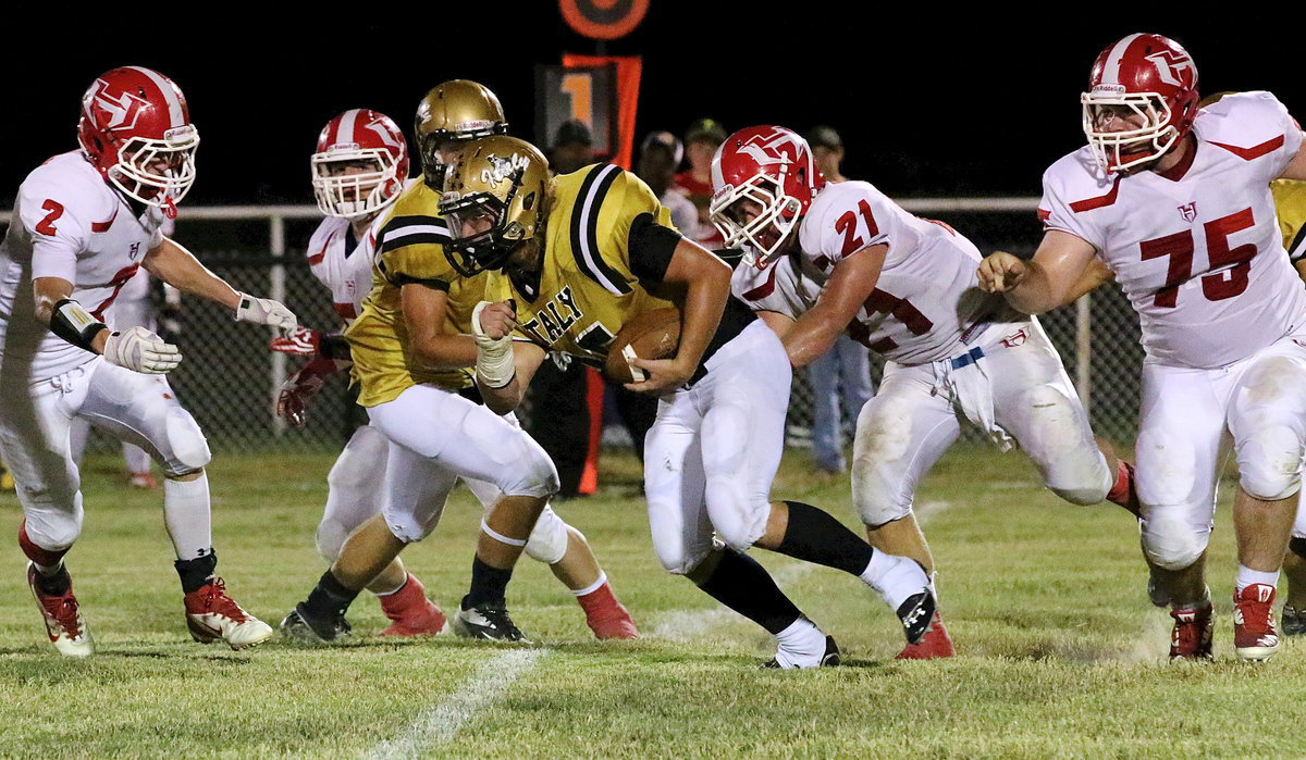 Image: Italy fullback Shad Newman(25) fights his way thru hopeful Hico tacklers.