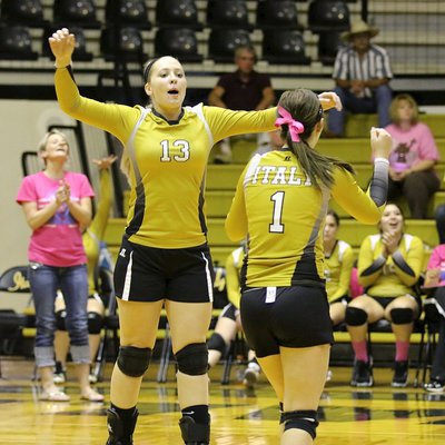 Image: Jaclynn Lewis(15) and Bailey Eubank(1) celebrate an Italy point.