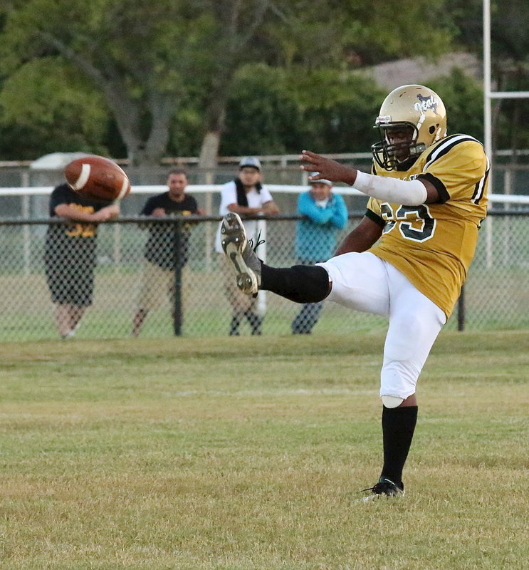 Image: JV Gladiator Kenneth Norwood, Jr.(63), punts the ball to Itasca.