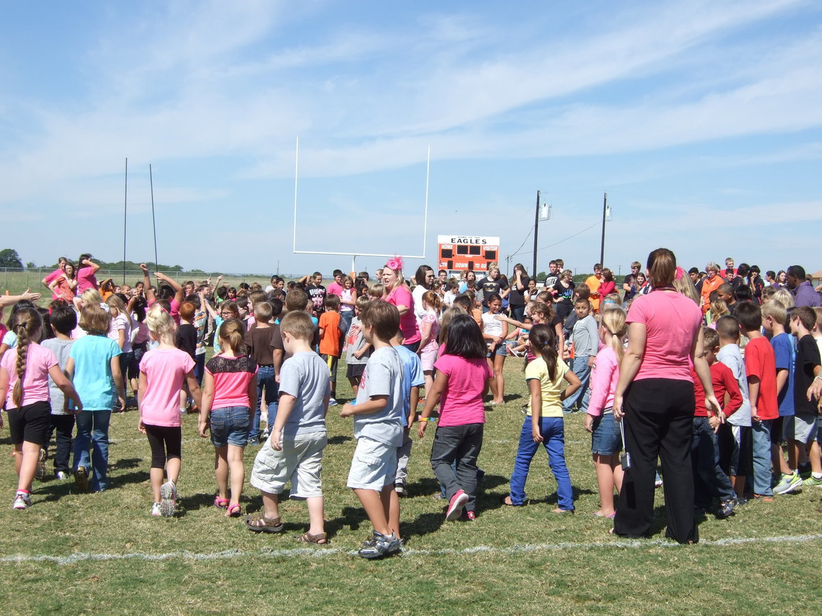 Image: Avalon students creating an A formation on the football field for Dr. Del Bosque to take an aerial picture.