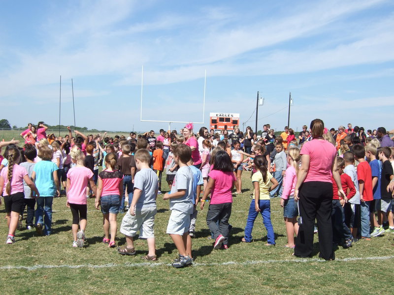 Image: Avalon students creating an A formation on the football field for Dr. Del Bosque to take an aerial picture.