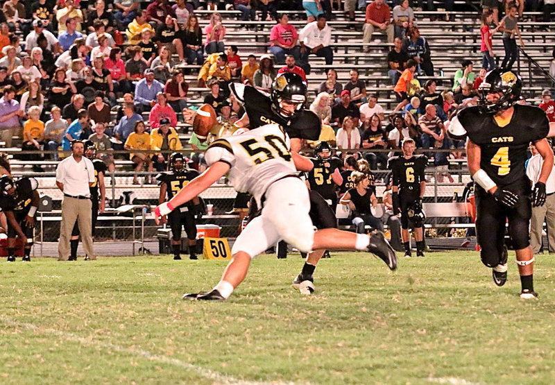 Image: Zain Byers(50) sacks Itasca’s quarterback and jars the ball loose with his helmet.