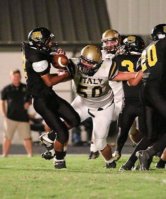 Image: Hello! Zain Byers(50) greets a Cat runner for a loss in the backfield near Italy’s goal line.