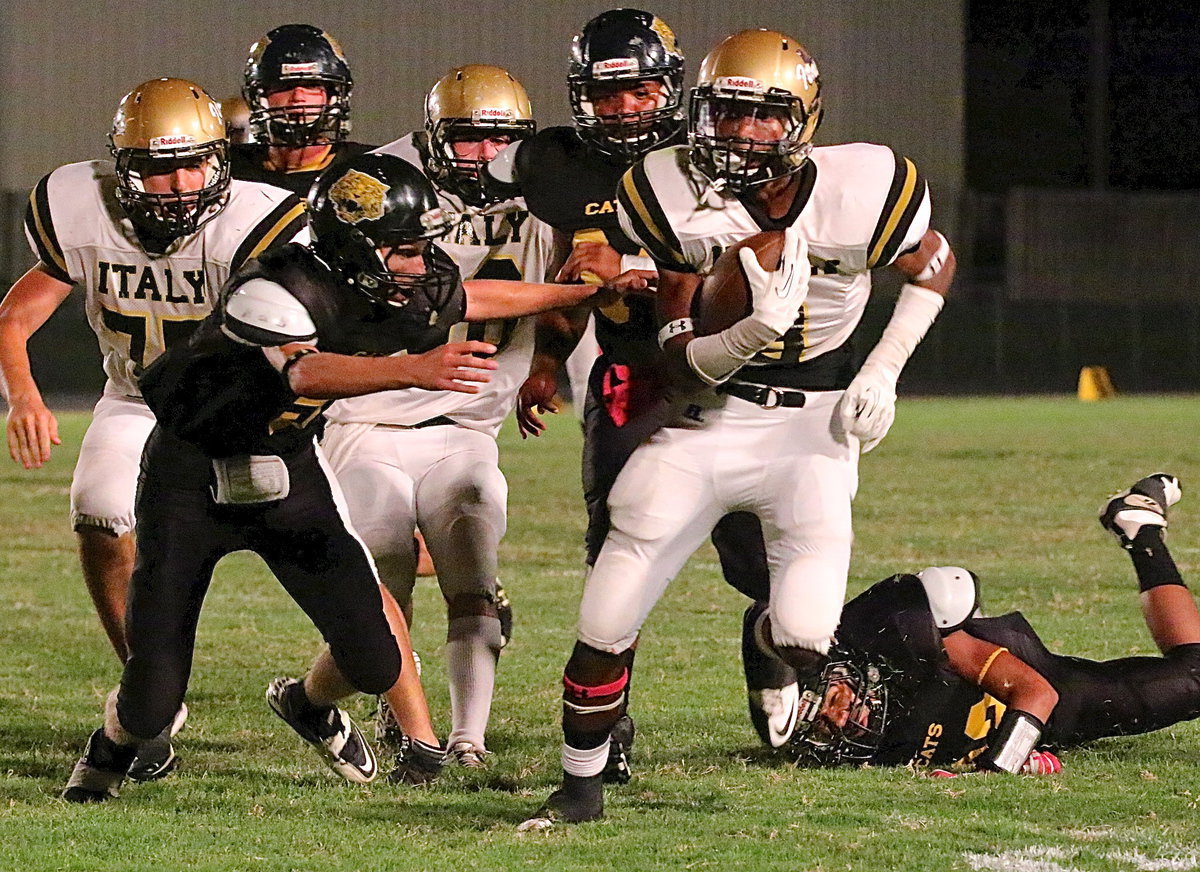 Image: Italy’s Trevon Robertson(3) eludes Cats pawing at his heels to turn a short pass into a 36 yard touchdown.
