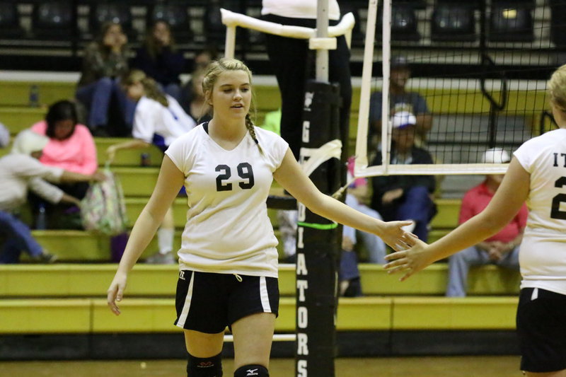 Image: Grace Haight(29) gives Brycelen Richards(23) five after an Italy point.