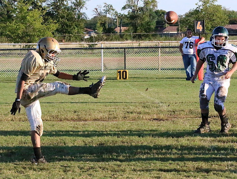 Image: Marcos Duarte(18) punts the ball over to Cross Roads.