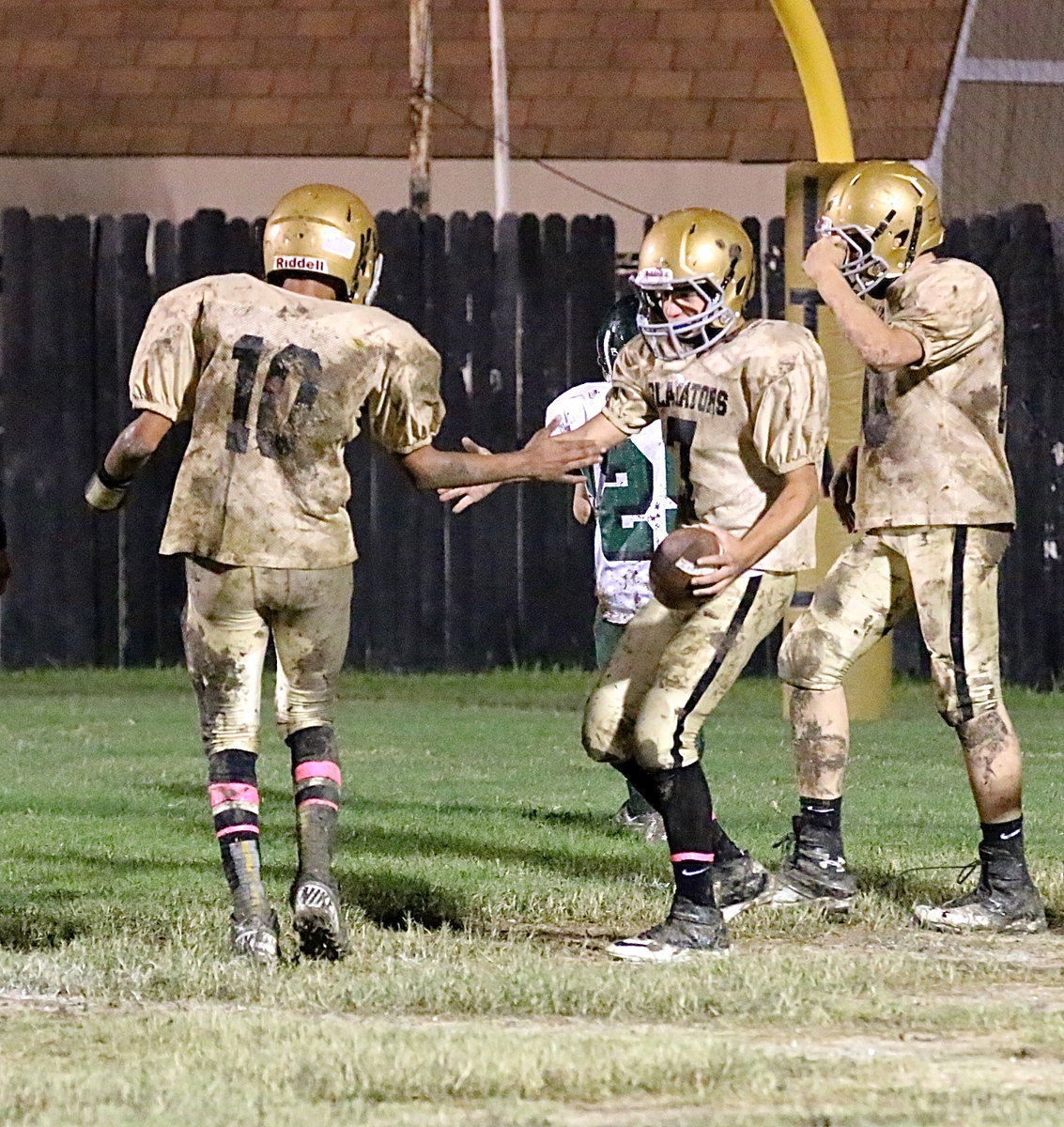 Image: Wallace and Escamilla congratulate each other after combining for their second passing touchdown against Crossroads.