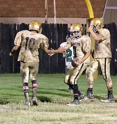 Image: Wallace and Escamilla congratulate each other after combining for their second passing touchdown against Crossroads.