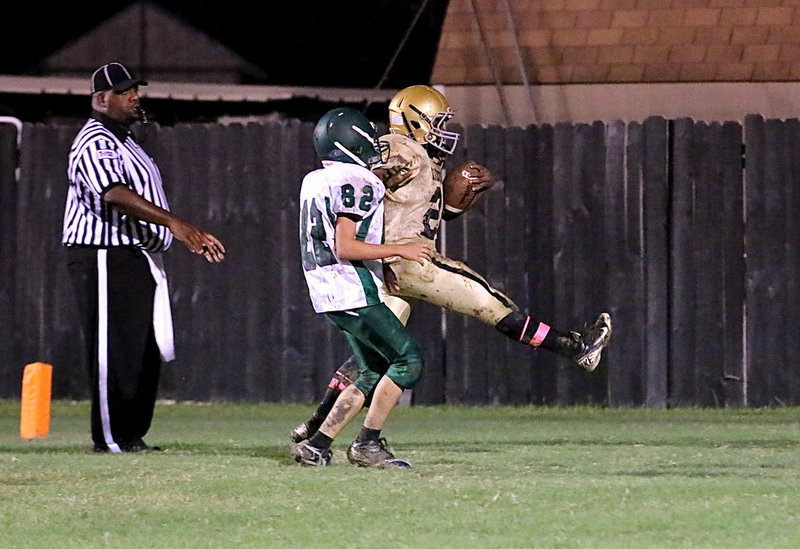 Image: Kendrick Norwood(20) high kicks into the end zone to keep a Bobcat tackler from bringing him down after completing one of the longest 2-point conversion plays in the history of football.