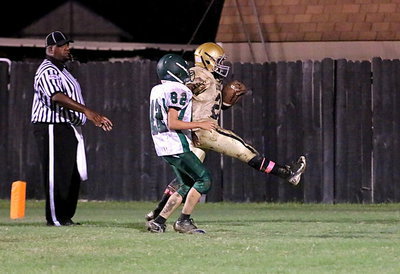 Image: Kendrick Norwood(20) high kicks into the end zone to keep a Bobcat tackler from bringing him down after completing one of the longest 2-point conversion plays in the history of football.