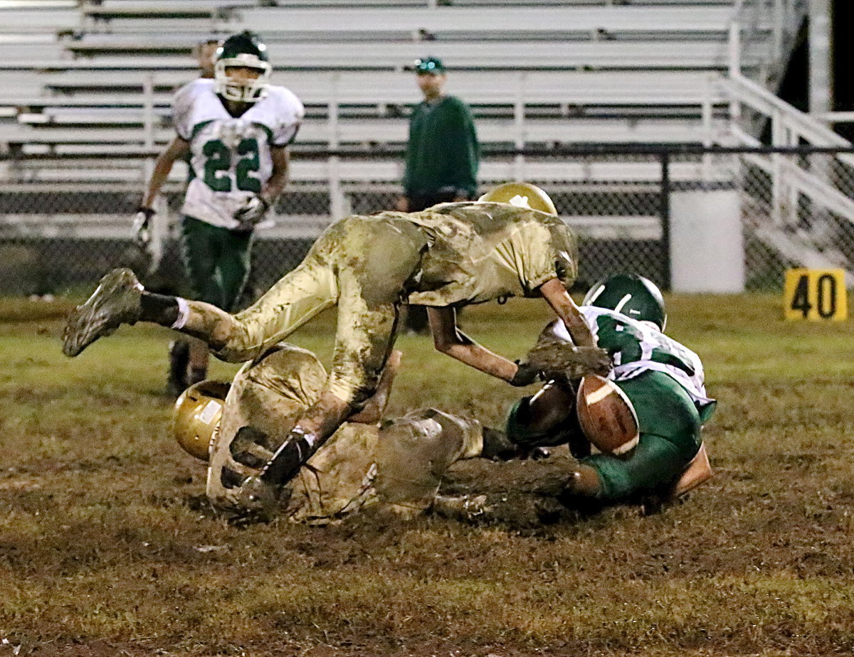 Image: Tylan Wallace(10) and Garrett Janek(10) combine to strip the football during a kick return by the Bobcats.