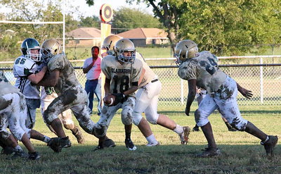 Image: Marcos Duarte(18) hands off to Adam Powell(24) who runs behind effective line blocking for Italy.