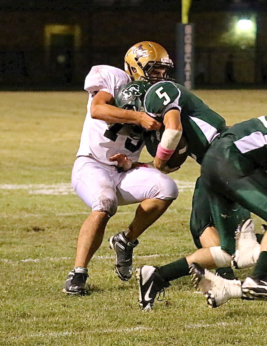 Image: Italy senior linebacker Cody Medrano(75) pulls down a Bobcat runner.