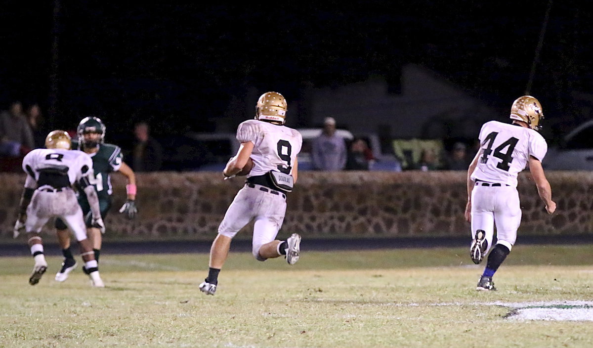 Image: Coby Bland(44) and Trevon Robertson(8) lead Hunter Merimon(9) down the field during 1 of his 31 carries on the night.