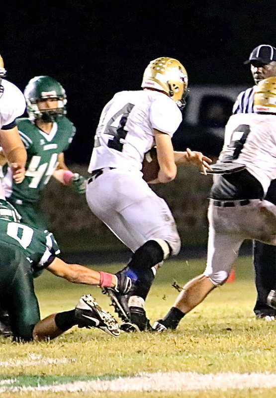 Image: Gladiator back Coby Bland(44) maneuvers for yards behind a block by Hunter Merimon(9).