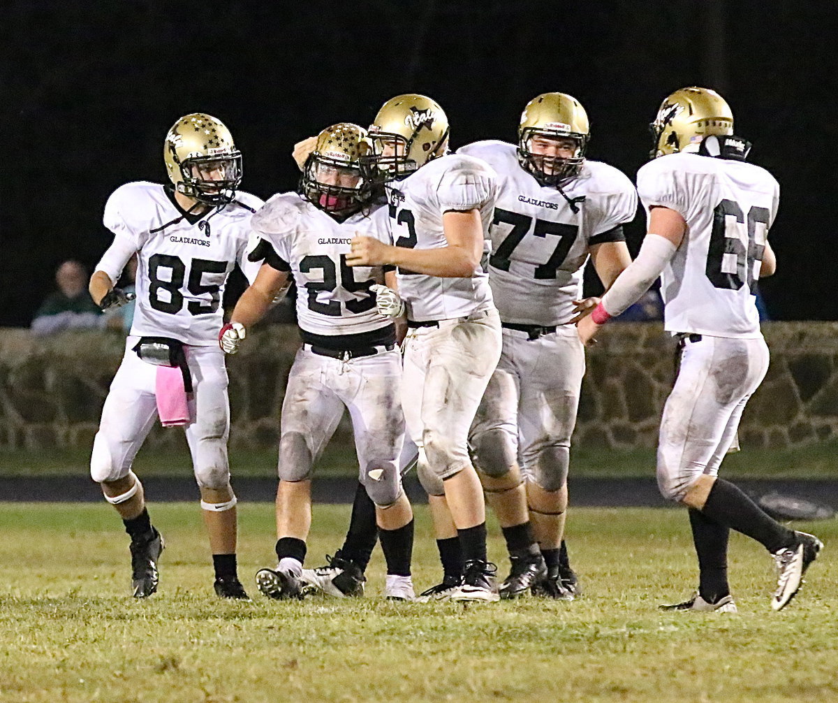 Image: Bailey Walton(52), Levi McBride(85), Kevin Roldan(77) and Kyle Fortenberry(66) congratulate linebacker Shad Newman after he made a key interception to setup Italy’s win sealing touchdown drive.