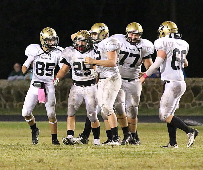 Image: Bailey Walton(52), Levi McBride(85), Kevin Roldan(77) and Kyle Fortenberry(66) congratulate linebacker Shad Newman after he made a key interception to setup Italy’s win sealing touchdown drive.