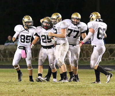 Image: Bailey Walton(52), Levi McBride(85), Kevin Roldan(77) and Kyle Fortenberry(66) congratulate linebacker Shad Newman after he made a key interception to setup Italy’s win sealing touchdown drive.
