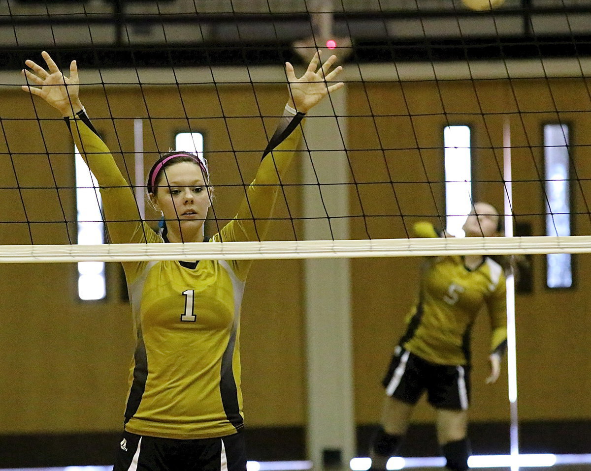 Image: Bailey Eubank(1) is ready at the net with teammate Tara Wallis(5) serving.