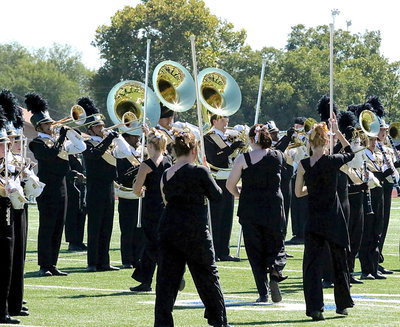 Image: The Color Guard maneuvers thru the ranks as the band plays on.