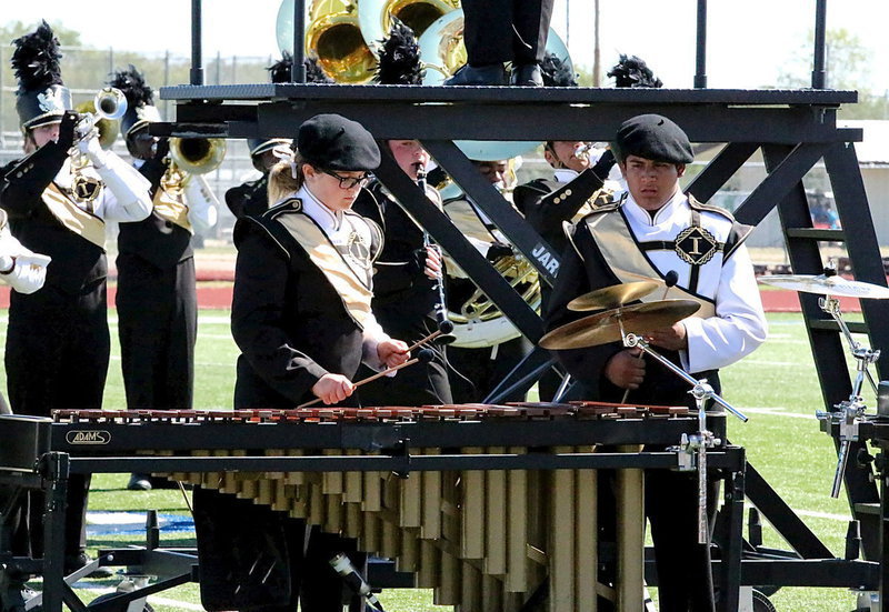 Image: Reagan Adams plays the marimba with assistance from band mate Chris Davila.