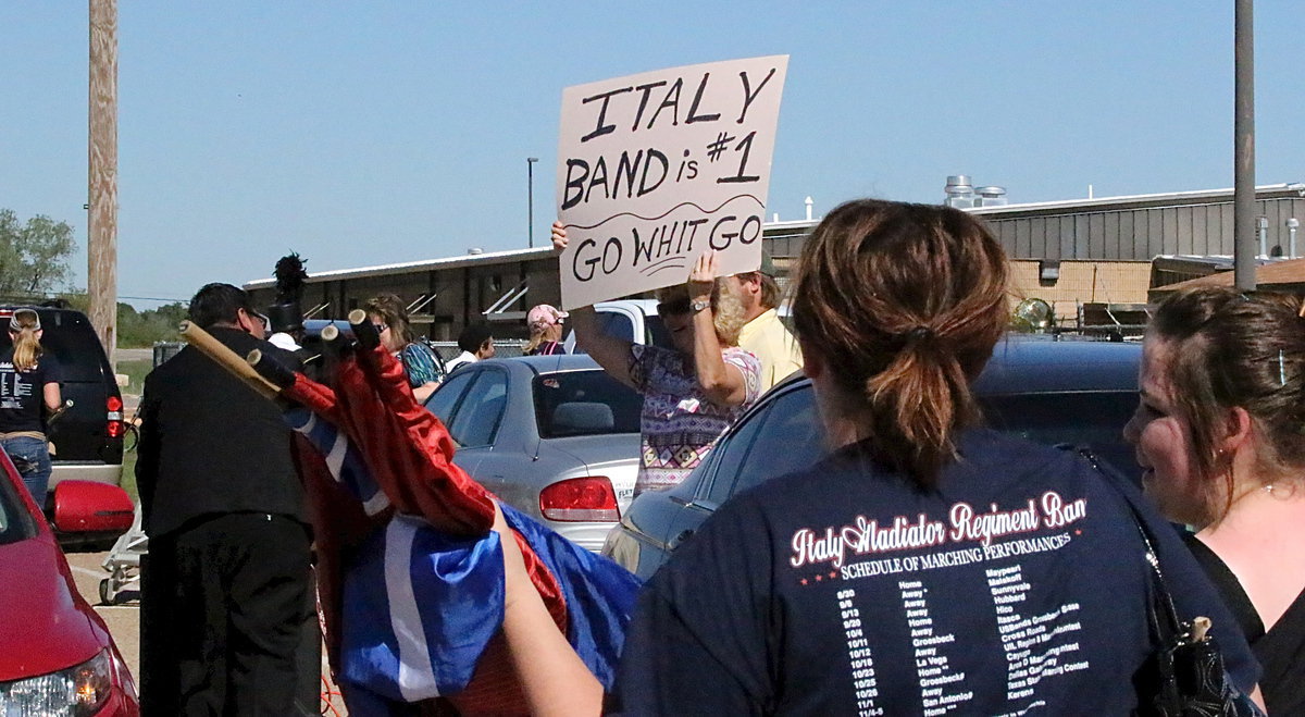Image: The moment you transform from a high school band to rock stars! Band Director Jesus Perez, color guard sponsor Amber Droll and the rest of the band are treated like celebrities after exiting the field.